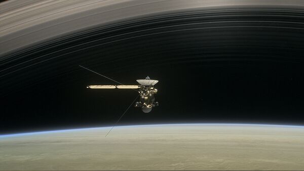 This image made available by NASA in April 2017 shows a still from the short film Cassini's Grand Finale, with the spacecraft diving between Saturn and the planet's innermost ring - Sputnik International