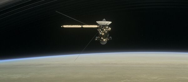 This image made available by NASA in April 2017 shows a still from the short film Cassini's Grand Finale, with the spacecraft diving between Saturn and the planet's innermost ring This image made available by NASA in April 2017 shows a still from the short film Cassini's Grand Finale, with the spacecraft diving between Saturn and the planet's innermost ring - Sputnik International