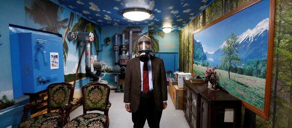 Seiichiro Nishimoto, CEO of Shelter Co., poses wearing a gas mask at a model room for the company's nuclear shelters in the basement of his house in Osaka, Japan April 26, 2017 Seiichiro Nishimoto, CEO of Shelter Co., poses wearing a gas mask at a model room for the company's nuclear shelters in the basement of his house in Osaka, Japan April 26, 2017 - Sputnik International