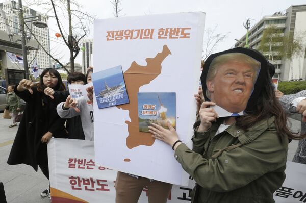 Protesters hold a cutout of US President Donald Trump and images of the USS Carl Vinson aircraft carrier and US missile defense system THAAD, right, on a map of Korean Peninsula during a rally against US deployment of the aircraft carrier to the Korean Peninsula, near the US embassy in Seoul, South Korea, Thursday, April 13, 2017 Protesters hold a cutout of US President Donald Trump and images of the USS Carl Vinson aircraft carrier and US missile defense system THAAD, right, on a map of Korean Peninsula during a rally against US deployment of the aircraft carrier to the Korean Peninsula, near the US embassy in Seoul, South Korea, Thursday, April 13, 2017 - Sputnik International