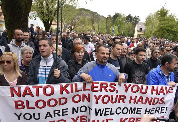 Anti-NATO demonstrators hold a banner during a protest outside the hall before the parliament session in Cetinje, Montenegro, Friday, April 28, 2017 Anti-NATO demonstrators hold a banner during a protest outside the hall before the parliament session in Cetinje, Montenegro, Friday, April 28, 2017 - Sputnik International