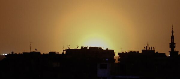 A photo taken from the rebel-held town of Douma shows flames rising in the distance which are believed to be coming from Damascus International Airport following an explosion early in the morning of April 27, 2017 - Sputnik International