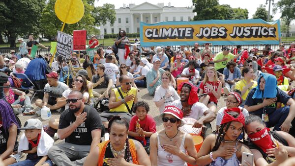 Demonstrators sit on the ground along Pennsylvania Ave. in front of the White House in Washington, Saturday, April 29, 2017, during a demonstration and march. - Sputnik International