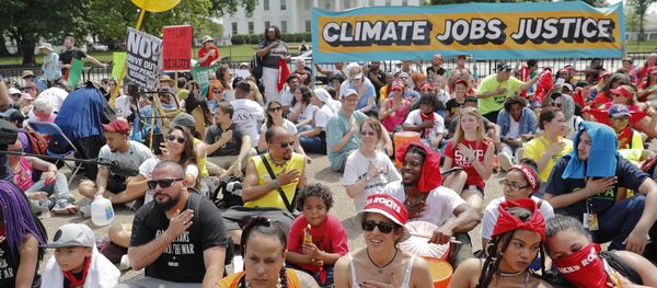 Demonstrators sit on the ground along Pennsylvania Ave. in front of the White House in Washington, Saturday, April 29, 2017, during a demonstration and march. Demonstrators sit on the ground along Pennsylvania Ave. in front of the White House in Washington, Saturday, April 29, 2017, during a demonstration and march. - Sputnik International