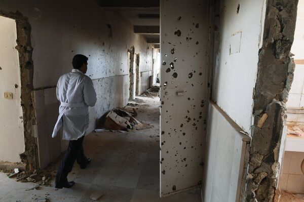 An employee in the corridor of Assad Hospital in Deir ez-Zor, Syria. An employee in the corridor of Assad Hospital in Deir ez-Zor, Syria. - Sputnik International