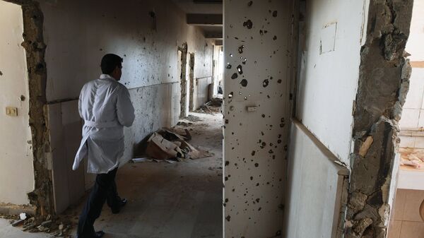 An employee in the corridor of Assad Hospital in Deir ez-Zor, Syria. - Sputnik International