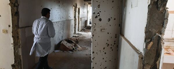 An employee in the corridor of Assad Hospital in Deir ez-Zor, Syria. An employee in the corridor of Assad Hospital in Deir ez-Zor, Syria. - Sputnik International