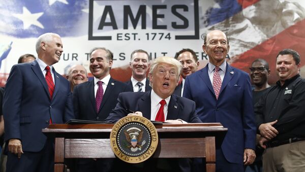 President Donald Trump, joined by Vice President Mike Pence, Secretary of Veterans Affairs David Shulkin, Secretary of Commerce Wilbur Ross, and others looks up as he signs an Executive Order on the Establishment of Office of Trade and Manufacturing Policy at The AMES Companies, Inc., in Harrisburg, Pa., Saturday, April, 29, 2017 - Sputnik International