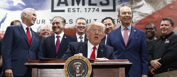 President Donald Trump, joined by Vice President Mike Pence, Secretary of Veterans Affairs David Shulkin, Secretary of Commerce Wilbur Ross, and others looks up as he signs an Executive Order on the Establishment of Office of Trade and Manufacturing Policy at The AMES Companies, Inc., in Harrisburg, Pa., Saturday, April, 29, 2017 - Sputnik International