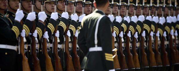 A Chinese People's Liberation Army soldier watches the position of members of a guard of honor as they prepare for a welcome ceremony for visiting Indian Prime Minister Manmohan Singh, outside the Great Hall of the People in Beijing Wednesday, Oct. 23, 2013. A Chinese People's Liberation Army soldier watches the position of members of a guard of honor as they prepare for a welcome ceremony for visiting Indian Prime Minister Manmohan Singh, outside the Great Hall of the People in Beijing Wednesday, Oct. 23, 2013. - Sputnik International