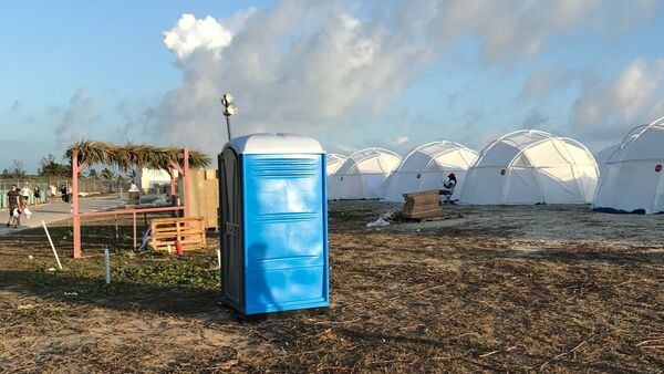 This photo provided by Jake Strang shows tents and a portable toilet set up for attendees for the Fyre Festival, Friday, April 28, 2017 in the Exuma islands, Bahamas. Organizers of the much-hyped music festival in the Bahamas canceled the weekend event at the last minute Friday after many people had already arrived and spent thousands of dollars on tickets and travel. - Sputnik International