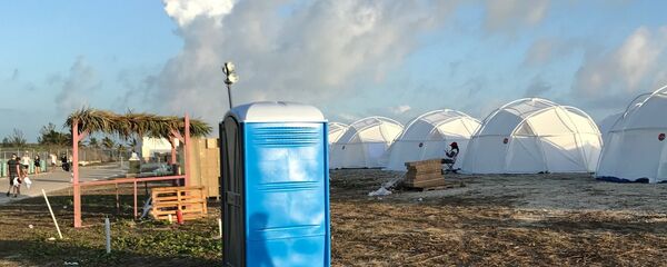 This photo provided by Jake Strang shows tents and a portable toilet set up for attendees for the Fyre Festival, Friday, April 28, 2017 in the Exuma islands, Bahamas. Organizers of the much-hyped music festival in the Bahamas canceled the weekend event at the last minute Friday after many people had already arrived and spent thousands of dollars on tickets and travel. - Sputnik International