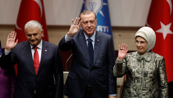 Turkish President Tayyip Erdogan greets his supporters after a speech as he is flanked by his wife Emine Erdogan and Prime Minister Binali Yildirim at the ruling AK Party's headquarters in Ankara, Turkey, May 2, 2017 - Sputnik International
