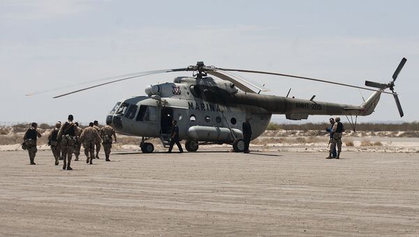 Mexican Navy marines prepare to board a helicopter as they continue their search and rescue efforts for survivors of a fishing boat accident in the town of San Felipe, Mexico, Tuesday July 5, 2011 - Sputnik International