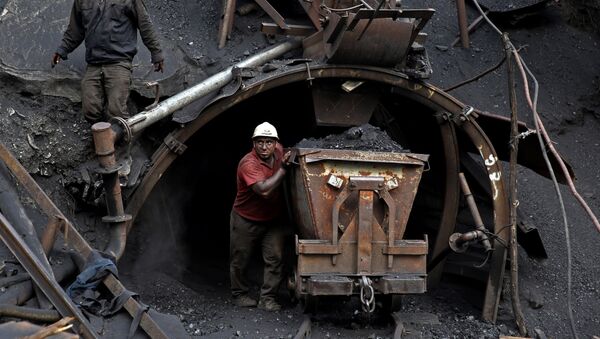 (File) In this Monday, Aug. 18, 2014 photo, an Iranian coal miner pushes a metal cart loaded with coal at a mine near the city of Zirab 212 kilometers (132 miles) northeast of the capital Tehran, on a mountain in Mazandaran province, Iran - Sputnik International