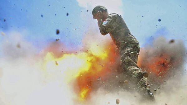 U.S Army combat camera photographer Spc. Hilda Clayton took this photo July 2, 2013 that was released by the U.S. Army, that shows an Afghan soldier engulfed in flame as a mortar tube explodes during an Afghan National Army live-fire training exercise in Laghman Province, Afghanistan. The accident killed Clayton and four Afghan National Army soldiers - Sputnik International