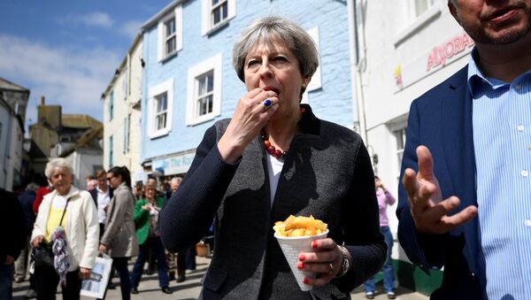 Britain's Prime Minister Theresa May enjoys some chips during a campaign stop in Mevagissey, Cornwall, May 2, 2017 - Sputnik International