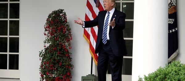 US President Donald Trump speaks to staffers setting up for the Commander in Chief's trophy presentation in the Rose Garden of the White House in Washington, US, May 2, 2017. - Sputnik International