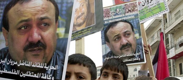 Palestinian youths hold pictures of Palestinian uprising leader Marwan Barghouti, detained in Israel, during a prisoners rally in the West Bank town of Ramallah Tuesday, April 15, 2003. Palestinian youths hold pictures of Palestinian uprising leader Marwan Barghouti, detained in Israel, during a prisoners rally in the West Bank town of Ramallah Tuesday, April 15, 2003. - Sputnik International