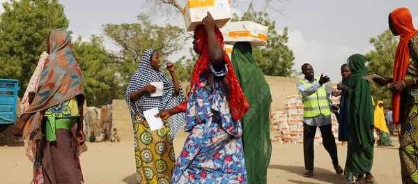 Women carry food supplement received from World Food Programme (WFP) at the Banki IDP camp, in Borno, Nigeria April 26, 2017 Women carry food supplement received from World Food Programme (WFP) at the Banki IDP camp, in Borno, Nigeria April 26, 2017 - Sputnik International