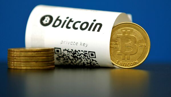 A Bitcoin (virtual currency) paper wallet with QR codes and a coin are seen in an illustration picture taken at La Maison du Bitcoin in Paris, France May 27, 2015 - Sputnik International
