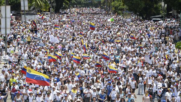 Venezuelan opposition activists take part in a women's march aimed to keep pressure on President Nicolas Maduro, whose authority is being increasingly challenged by protests and deadly unrest, in Caracas - Sputnik International