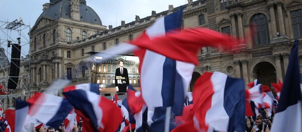 President Elect Emmanuel Macron is seen on a giant screen near the Louvre museum after results were announced in the second round vote of the 2017 French presidential elections - Sputnik International