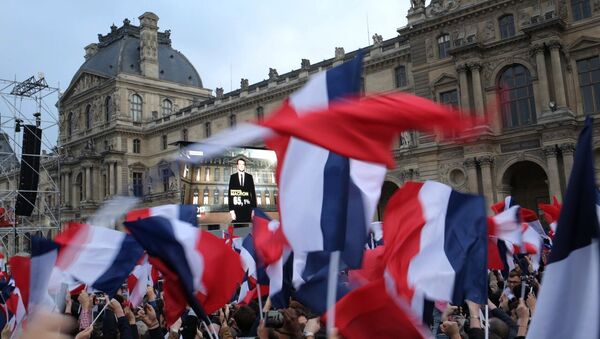 President Elect Emmanuel Macron is seen on a giant screen near the Louvre museum after results were announced in the second round vote of the 2017 French presidential elections - Sputnik International