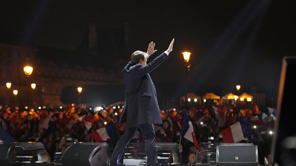 French president-elect Emmanuel Macron waves at supporters as he arrives on stage before delivering a speech in front of the Pyramid at the Louvre Museum in Paris on May 7, 2017, after the second round of the French presidential election. - Sputnik International