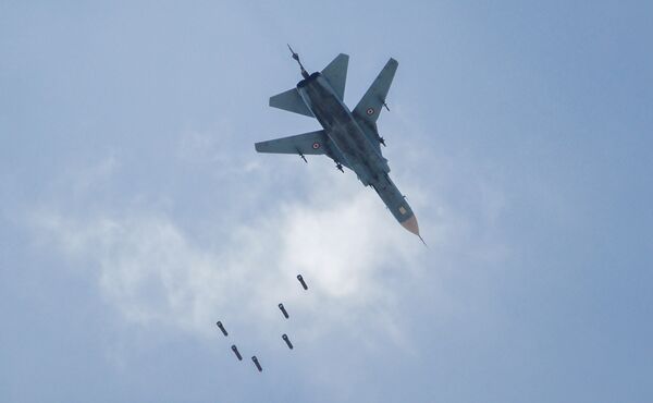 A Syrian government forces' MiG-23 fighter-bomber drops a payload during a reported air strike in the rebel-held area of Qabun, east of the capital Damascus, on May 6, 2017. A Syrian government forces' MiG-23 fighter-bomber drops a payload during a reported air strike in the rebel-held area of Qabun, east of the capital Damascus, on May 6, 2017. - Sputnik International