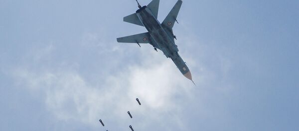 A Syrian government forces' MiG-23 fighter-bomber drops a payload during a reported air strike in the rebel-held area of Qabun, east of the capital Damascus, on May 6, 2017. A Syrian government forces' MiG-23 fighter-bomber drops a payload during a reported air strike in the rebel-held area of Qabun, east of the capital Damascus, on May 6, 2017. - Sputnik International
