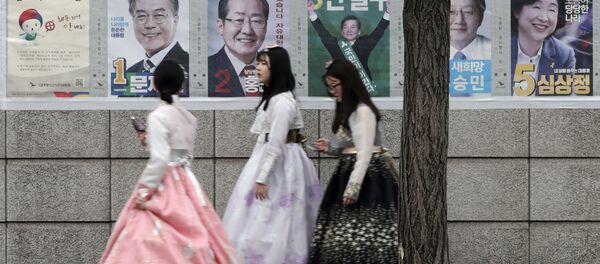 Women walk by posters showing candidates for the presidential election in Seoul, South Korea, Tuesday, May 9, 2017. Women walk by posters showing candidates for the presidential election in Seoul, South Korea, Tuesday, May 9, 2017. - Sputnik International