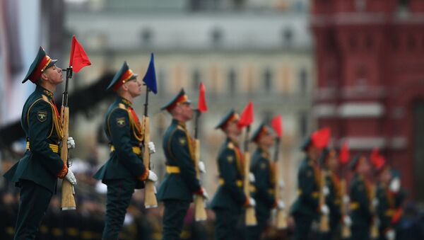 Russian servicemen stand in attention during the parade marking the World War II anniversary in Moscow. - Sputnik International
