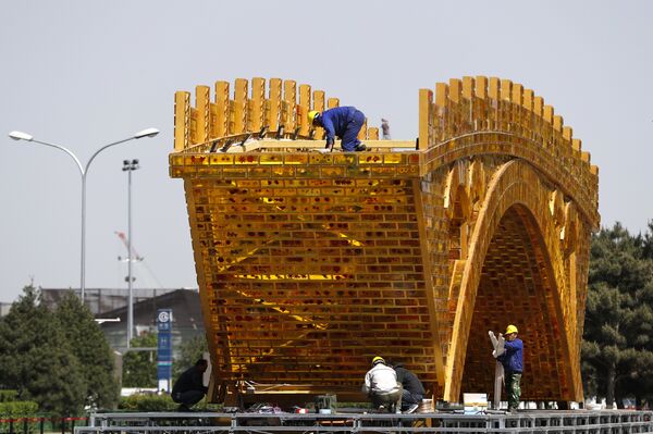 Workers install wires on a 'Golden Bridge of Silk Road' structure on a platform outside the National Convention Center, the venue which will hold the Belt and Road Forum for International Cooperation, in Beijing Workers install wires on a 'Golden Bridge of Silk Road' structure on a platform outside the National Convention Center, the venue which will hold the Belt and Road Forum for International Cooperation, in Beijing - Sputnik International