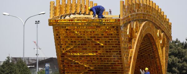 Workers install wires on a 'Golden Bridge of Silk Road' structure on a platform outside the National Convention Center, the venue which will hold the Belt and Road Forum for International Cooperation, in Beijing Workers install wires on a 'Golden Bridge of Silk Road' structure on a platform outside the National Convention Center, the venue which will hold the Belt and Road Forum for International Cooperation, in Beijing - Sputnik International