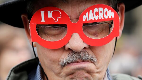 A demonstrator wears cardboard glasses with the message, I don't like Macron, in refererence to French president-elect Emmanuel Macron, as people gather to protest the day after the country went to the polls, in Paris, France, May 8, 2017. - Sputnik International