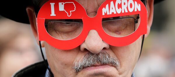 A demonstrator wears cardboard glasses with the message, I don't like Macron, in refererence to French president-elect Emmanuel Macron, as people gather to protest the day after the country went to the polls, in Paris, France, May 8, 2017. A demonstrator wears cardboard glasses with the message, I don't like Macron, in refererence to French president-elect Emmanuel Macron, as people gather to protest the day after the country went to the polls, in Paris, France, May 8, 2017. - Sputnik International