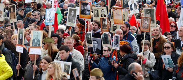 People carrying portraits of deceased relatives as they attend the Immortal Regiment march during the Victory Day celebrations at the Soviet War Memorial in Berlin, Germany People carrying portraits of deceased relatives as they attend the Immortal Regiment march during the Victory Day celebrations at the Soviet War Memorial in Berlin, Germany - Sputnik International