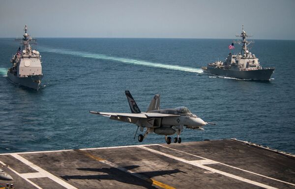 An F/A-18E Super Hornet lands on the flight deck of the U.S. Navy aircraft carrier USS Carl Vinson as the Ticonderoga-class guided-missile cruiser USS Lake Champlain (L) and the Arleigh Burke-class guided-missile destroyer USS Wayne E. Meyer transit the western Pacific Ocean May 3, 2017. An F/A-18E Super Hornet lands on the flight deck of the U.S. Navy aircraft carrier USS Carl Vinson as the Ticonderoga-class guided-missile cruiser USS Lake Champlain (L) and the Arleigh Burke-class guided-missile destroyer USS Wayne E. Meyer transit the western Pacific Ocean May 3, 2017. - Sputnik International