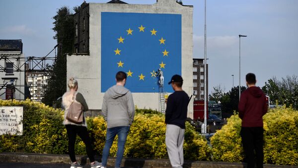 An artwork attributed to street artist Banksy, depicting a workman chipping away at one of the 12 stars on the flag of the European Union, is seen on a wall in the ferry port of Dover, Britain May 7, 2017. - Sputnik International
