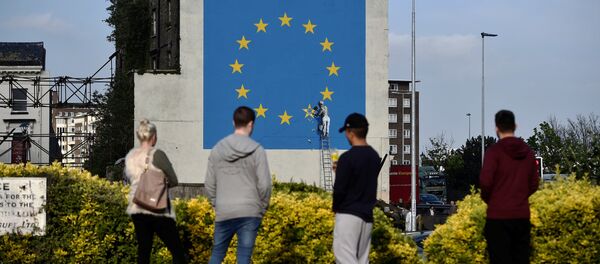 An artwork attributed to street artist Banksy, depicting a workman chipping away at one of the 12 stars on the flag of the European Union, is seen on a wall in the ferry port of Dover, Britain May 7, 2017. - Sputnik International