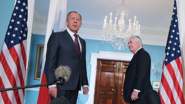 US Secretary of State Rex Tillerson (R) watches as Russian Foreign Minister Sergei Lavrov reacts to a reporter's question after posing for photos in the Treaty Room of the State Department in Washington, DC on May 10, 2017. - Sputnik International