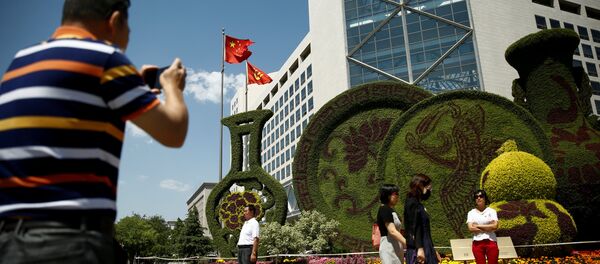 A man takes pictures of a flower display set up ahead of the Belt and Road Forum in central Beijing, China, May 10, 2017 A man takes pictures of a flower display set up ahead of the Belt and Road Forum in central Beijing, China, May 10, 2017 - Sputnik International