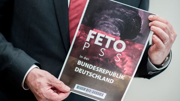 Lower Saxony's Interior Minister Boris Pistorius holds the cover of a list with the names of alleged supporters of the Gulen movement that was handed over to Germany's Federal Intelligence Service (Bundesnachrichtendienst) by representatives of the Turkish intelligence service, during a press conference in Hanover, central Germany, on March 28, 2017 - Sputnik International