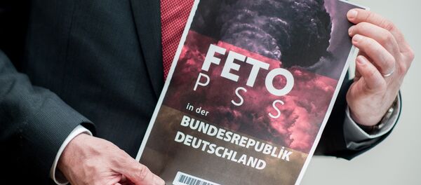 Lower Saxony's Interior Minister Boris Pistorius holds the cover of a list with the names of alleged supporters of the Gulen movement that was handed over to Germany's Federal Intelligence Service (Bundesnachrichtendienst) by representatives of the Turkish intelligence service, during a press conference in Hanover, central Germany, on March 28, 2017 - Sputnik International