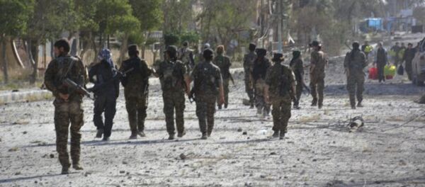 In this undated photo released Thursday, May 11, 2017, by Hawar News, the news agency for the semi-autonomous Kurdish areas in Syria, shows fighters from the Kurdish-led Syria Democratic Forces, patrolling on a street in Tabqa, northern Syria - Sputnik International