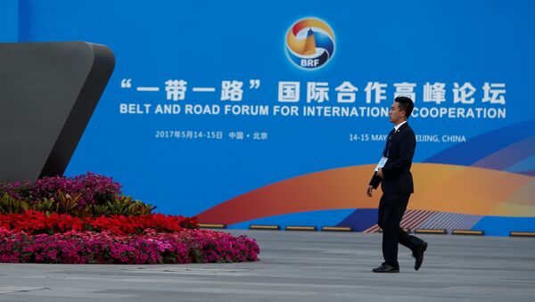 A man walks past the China National Convention Center, a venue of the upcoming Belt and Road Forum in Beijing, China, May 12, 2017 - Sputnik International