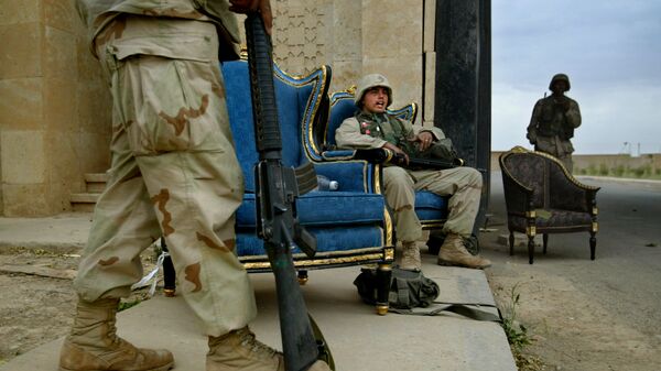 U.S. Marines, using luxurious armchairs, man one of the entrances to Saddam Hussein's presidential palace compound in the northern Iraqi town of Tikrit, Tuesday April 15, 2003 - Sputnik International