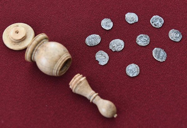 Hand minted silver coins from the time of Ivan the Terrible (16th century) that were found inside an ivory chess bishop figure shown as part of a display of archeological finds discovered in Prechistenka Street as it was being renovated under the My Street programme in Moscow Hand minted silver coins from the time of Ivan the Terrible (16th century) that were found inside an ivory chess bishop figure shown as part of a display of archeological finds discovered in Prechistenka Street as it was being renovated under the My Street programme in Moscow - Sputnik International