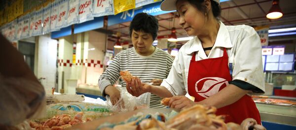 A clerk, right, helps a woman shop for chicken at a supermarket in Beijing, Friday, May 12, 2017 A clerk, right, helps a woman shop for chicken at a supermarket in Beijing, Friday, May 12, 2017 - Sputnik International